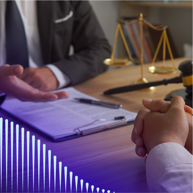 Two people sitting at a desk with a clipboard