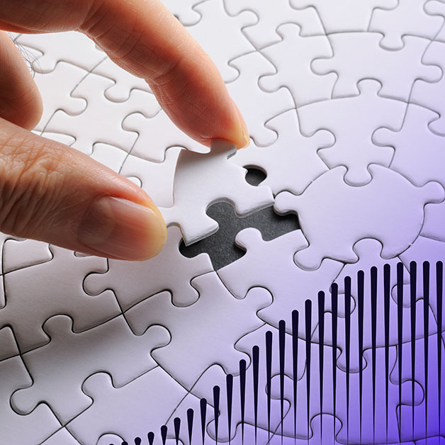 Hand placing down white puzzle piece