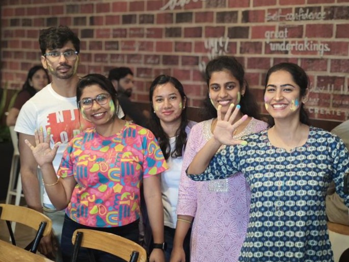 Five Ansira employees with paint on their faces celebrating Holi