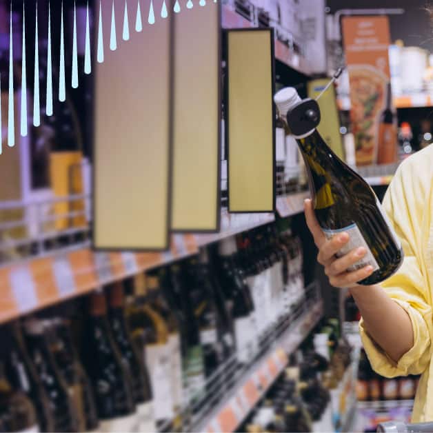 Person holding a bottle at a liquor store