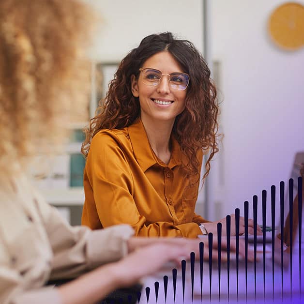 Woman smiling at another woman