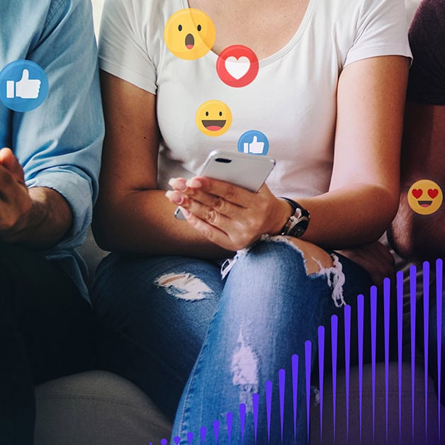 Woman on her phone with social media reactions floating above it