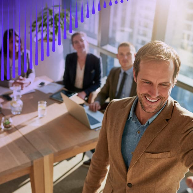 Man presenting something to three people sitting at a table