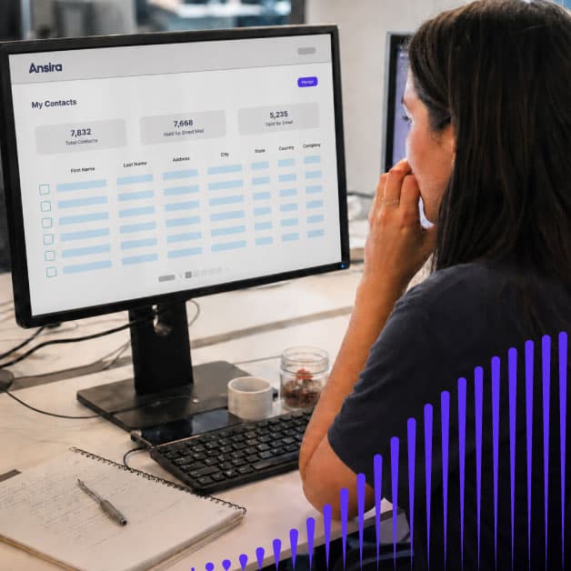 Woman looking at a computer screen with the Ansira Connect platform on it